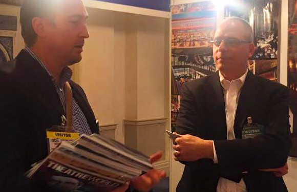 Jack Muffoletto at the ISBE tradeshow Booth for TK Architects, meeting with a Visitor